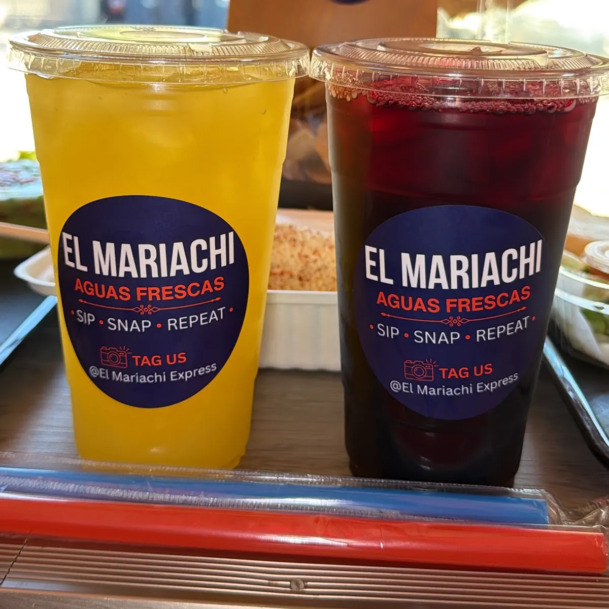 Mango and jamaica aguas frescas with El Mariachi Express stickers: sip, snap, repeat